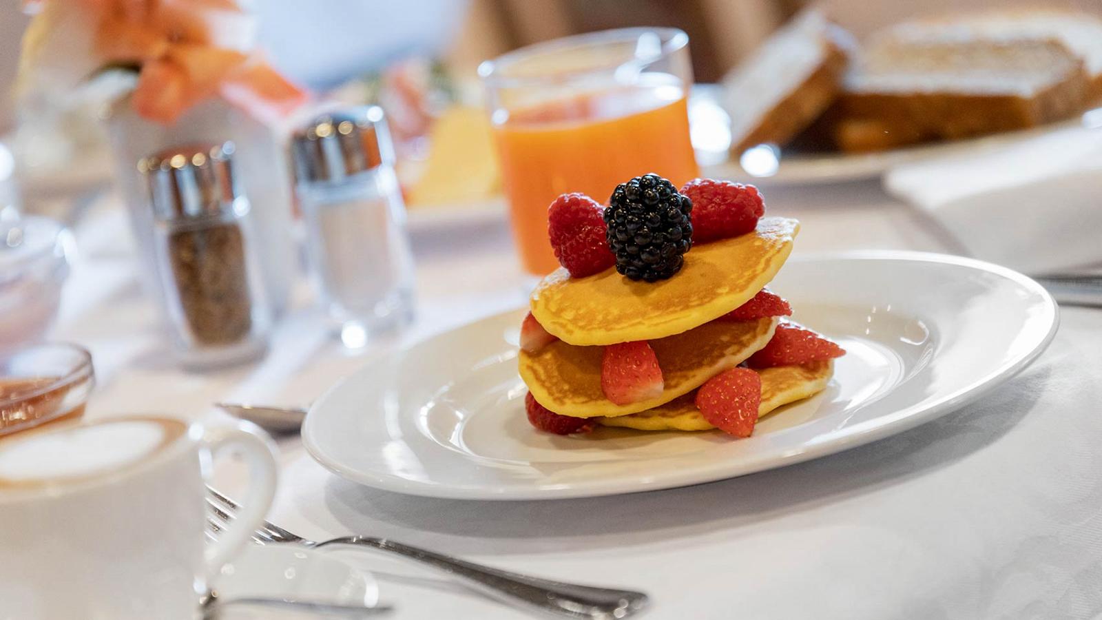 Detail of pancakes with blackberries and strawberries at the Hotel in Moena